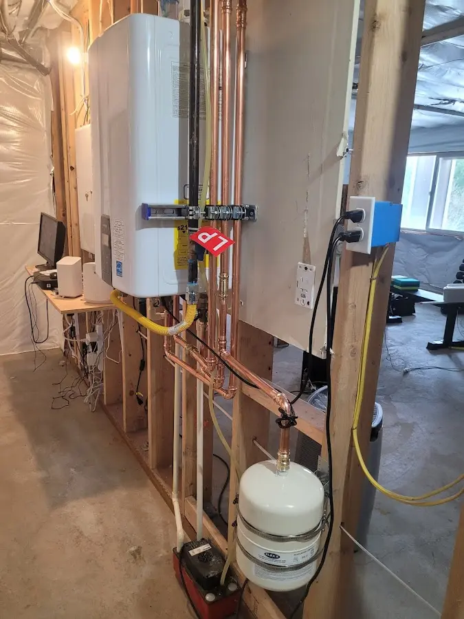 Licensed plumber repairing a kitchen sink in Ossipee